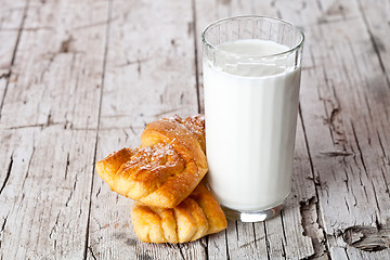 Image showing glass of milk and two fresh baked buns 