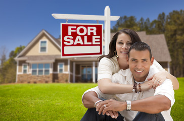Image showing Hispanic Couple, New Home and For Sale Real Estate Sign