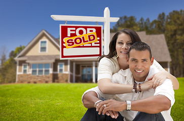 Image showing Hispanic Couple, New Home and Sold Real Estate Sign