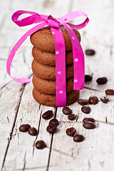 Image showing stack of chocolate cookies tied with pink ribbon and coffee bean