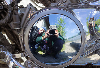 Image showing Two motorcyclists are reflected in brilliant motor
