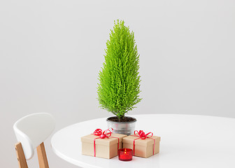 Image showing Little Christmas tree and gifts on a table