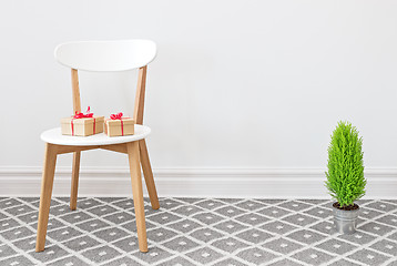 Image showing Presents on a white chair, and little green tree