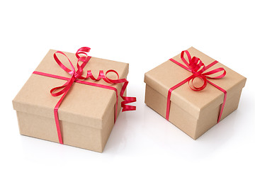 Image showing Two gift boxes with red ribbons on white background