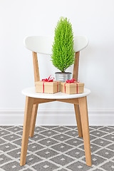 Image showing Presents and little green tree on a white chair