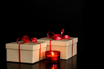 Image showing Elegant presents and red candlelight