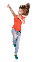 Image showing Jumping girl pointing to the side