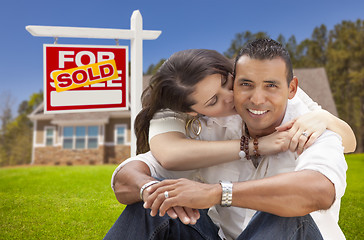 Image showing Hispanic Couple, New Home and Sold Real Estate Sign