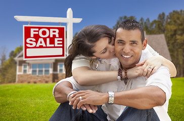 Image showing Hispanic Couple, New Home and For Sale Real Estate Sign