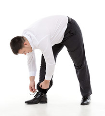 Image showing Man bending down to do up his shoelaces