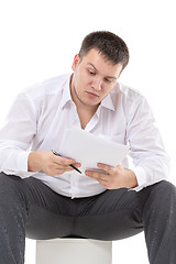 Image showing Businessman reading a report with scepticism