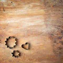 Image showing pastry cutters on wooden cutting board