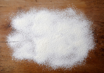 Image showing white flour on wooden table