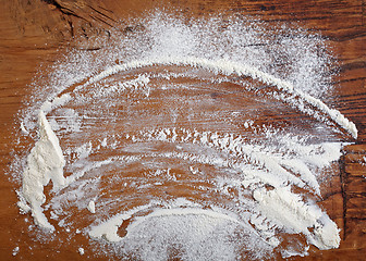 Image showing white flour on wooden table