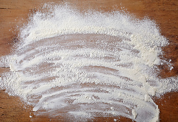 Image showing white flour on wooden table