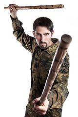 Image showing Self defense instructor with bamboo sticks