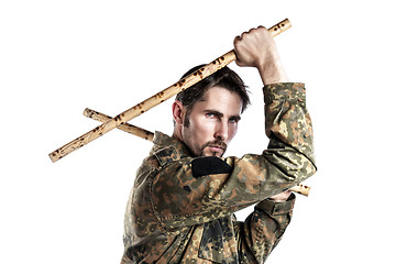 Image showing Self defense instructor with bamboo sticks