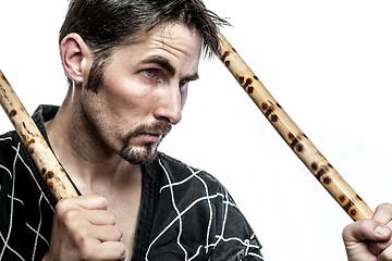 Image showing Martial arts master with bamboo sticks