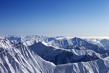 Image showing Snowy rocks and blue sky in nice sun day, view from off piste sl