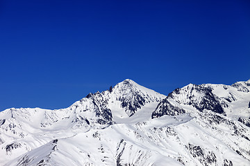 Image showing Winter snowy mountains and blue clear sky