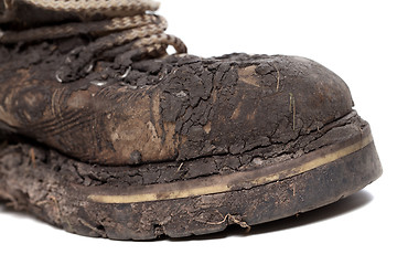 Image showing Old dirty hiking boot isolated on white background