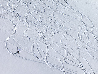 Image showing Snowboarder downhill on off piste slope with newly-fallen snow