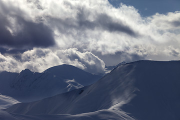 Image showing Off piste slope in sunlight clouds at evening