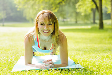 Image showing Woman holding plank pose outside