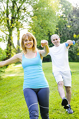 Image showing Personal trainer with client exercising in park