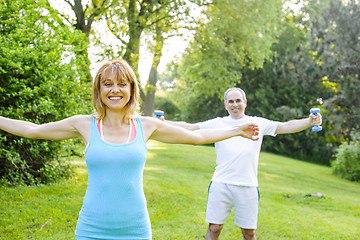 Image showing Personal trainer with client exercising outside