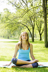 Image showing Woman in lotus yoga pose outside