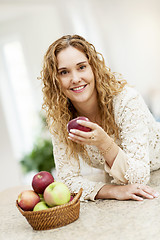 Image showing Smiling woman holding apple