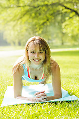 Image showing Woman holding plank pose outside