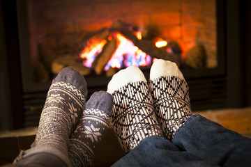 Image showing Feet warming by fireplace