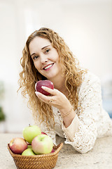 Image showing Smiling woman holding apple