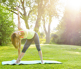 Image showing Woman in yoga triangle pose