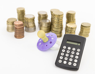 Image showing pacifier with hard money and pocket calculator