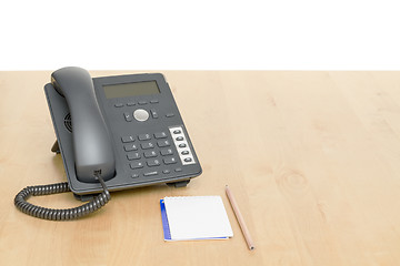 Image showing phone on desk with notepad on wooden desk