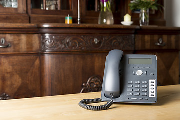 Image showing phone on wooden table in living room