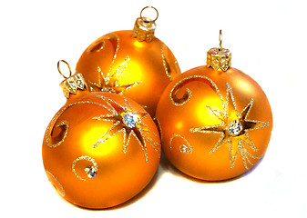 Image showing Three orange Christmas balls with golden pattern
