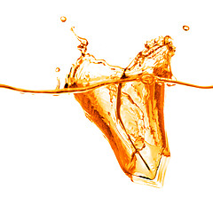 Image showing ice cubes dropped into orange water with splash isolated on whit