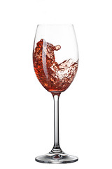 Image showing Red wine pouring into glass with splash isolated on white