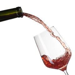 Image showing Red wine pouring into glass with splash isolated on white