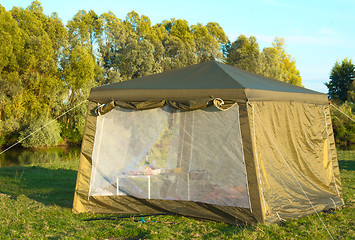 Image showing A big tourist tent on the Bank of the river.