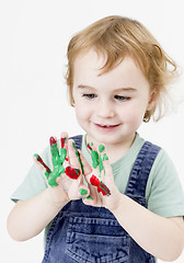 Image showing cute little girl with finger paint