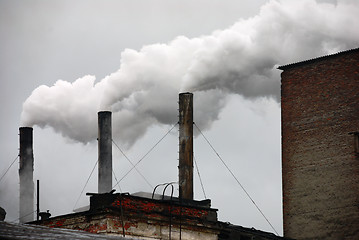 Image showing three smoking factory chimneys 