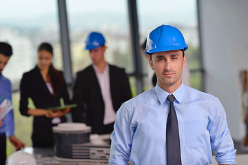 Image showing business people and construction engineers on meeting