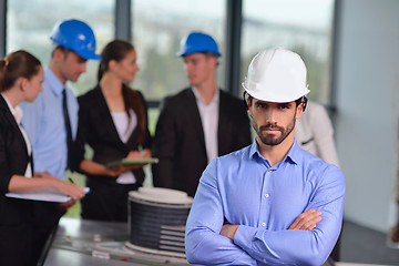 Image showing business people and construction engineers on meeting