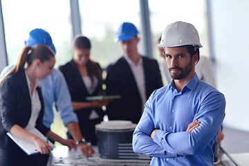 Image showing business people and construction engineers on meeting