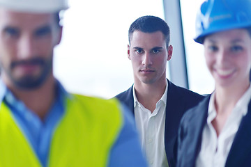 Image showing business people and construction engineers on meeting